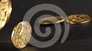 Golden bitcoin physical coins fall and bounce