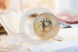 Golden bitcoin on real money background