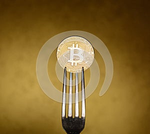 Golden bitcoin in with silver fork