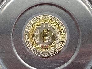 Golden bitcoin on silver metal background, bitcoin is most popular crypto currency with copy space