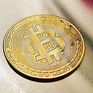 Golden bitcoin on silver metal background, bitcoin is most popular crypto currency with copy space