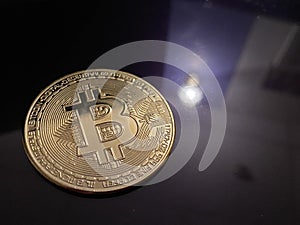 Golden bitcoin on silver metal background, bitcoin is most popular crypto currency with copy space