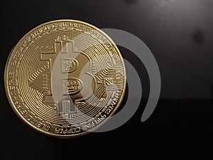 Golden bitcoin on silver metal background, bitcoin is most popular crypto currency with copy space