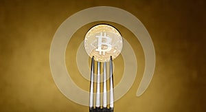 Golden bitcoin in siver fork on abstract background
