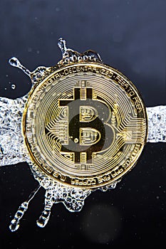 Golden bitcoin and water splash. Money laundering