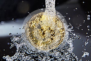Golden bitcoin and water splash. Money laundering