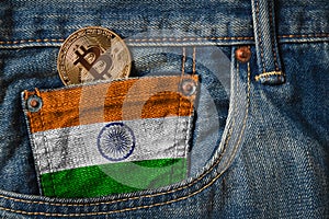 Golden BITCOIN (BTC) cryptocurrency in the pocket of jeans with