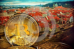 Golden Bitcoins on the background of Prague.