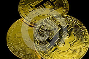 Golden bitcoins on black background
