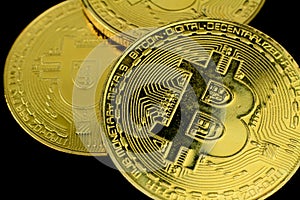 Golden bitcoins on black background