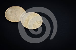 Golden bitcoins on black background