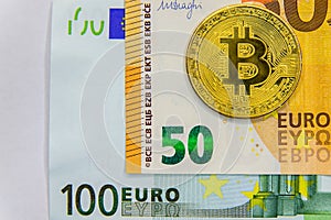 Golden Bitcoins close-up on euro currency background. High resolution photo