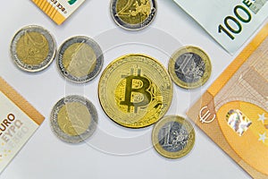 Golden Bitcoins close-up on euro currency background. High resolution photo