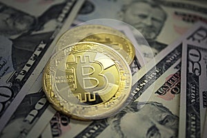 Golden Bitcoins Coins on US dollar bills. Electronic money exchange concept