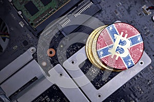 Golden bitcoins with confederate jack on a computer electronic circuit board. bitcoin mining concept