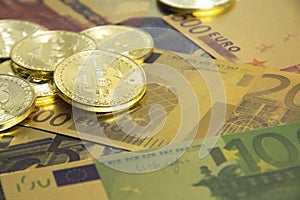 Golden bitcoins on euro banknotes, closee up