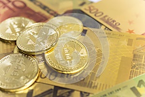 Golden bitcoins on euro banknotes, closee up