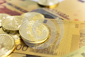 Golden bitcoins on euro banknotes, closee up