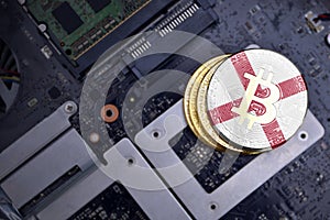 Golden bitcoins with flag of alabama state on a computer electronic circuit board. bitcoin mining concept