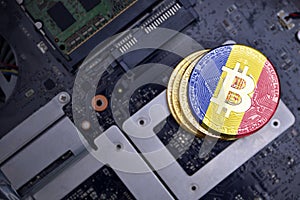 Golden bitcoins with flag of andorra on a computer electronic circuit board. bitcoin mining concept