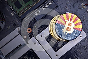 Golden bitcoins with flag of arizona state on a computer electronic circuit board. bitcoin mining concept