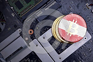 Golden bitcoins with flag of austria on a computer electronic circuit board. bitcoin mining concept