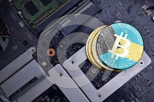 Golden bitcoins with flag of bahamas on a computer electronic circuit board. bitcoin mining concept