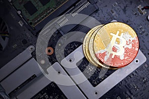 Golden bitcoins with flag of bhutan on a computer electronic circuit board. bitcoin mining concept