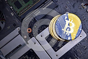 Golden bitcoins with flag of bosnia and herzegovina on a computer electronic circuit board. bitcoin mining concept