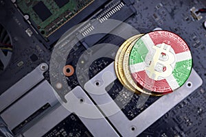 Golden bitcoins with flag of burundi on a computer electronic circuit board. bitcoin mining concept