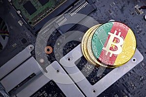 Golden bitcoins with flag of cameroon on a computer electronic circuit board. bitcoin mining concept