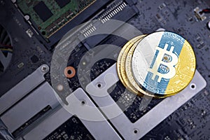 Golden bitcoins with flag of canary islands on a computer electronic circuit board. bitcoin mining concept