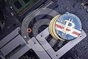 Golden bitcoins with flag of cape verde on a computer electronic circuit board. bitcoin mining concept