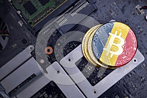 Golden bitcoins with flag of chad on a computer electronic circuit board. bitcoin mining concept