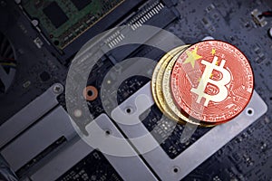 Golden bitcoins with flag of china on a computer electronic circuit board. bitcoin mining concept