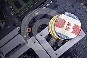 Golden bitcoins with flag of costa rica on a computer electronic circuit board. bitcoin mining concept