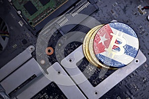 Golden bitcoins with flag of cuba on a computer electronic circuit board. bitcoin mining concept