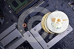 Golden bitcoins with flag of cyprus on a computer electronic circuit board. bitcoin mining concept