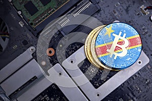 Golden bitcoins with flag of democratic republic of the congo on a computer electronic circuit board. bitcoin mining concept