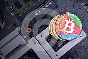 Golden bitcoins with flag of eritrea on a computer electronic circuit board. bitcoin mining concept