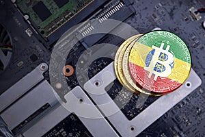 Golden bitcoins with flag of ethiopia on a computer electronic circuit board. bitcoin mining concept