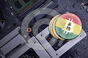 Golden bitcoins with flag of ghana on a computer electronic circuit board. bitcoin mining concept