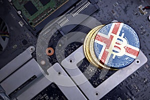 Golden bitcoins with flag of iceland on a computer electronic circuit board. bitcoin mining concept