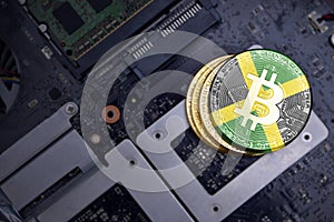 Golden bitcoins with flag of jamaica on a computer electronic circuit board. bitcoin mining concept