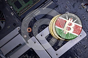 Golden bitcoins with flag of kenya on a computer electronic circuit board. bitcoin mining concept