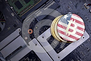 Golden bitcoins with flag of liberia on a computer electronic circuit board. bitcoin mining concept