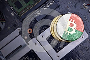 Golden bitcoins with flag of madagascar on a computer electronic circuit board. bitcoin mining concept