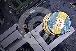 Golden bitcoins with flag of madeira on a computer electronic circuit board. bitcoin mining concept