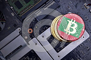 Golden bitcoins with flag of maldives on a computer electronic circuit board. bitcoin mining concept