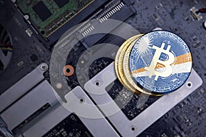 Golden bitcoins with flag of Marshall Islands on a computer electronic circuit board. bitcoin mining concept